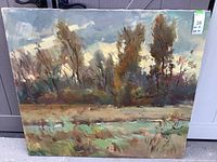 Front view of landscape oil painting on canvas depicting trees and grass, showing color tones and texture.