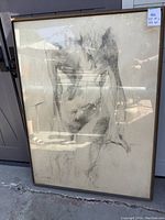 Full front view of the large framed sketch showing the nude figure bending, mounted and framed under glass with some reflections visible.