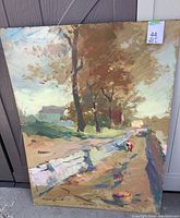 Full front view of the painting on board showing the rural landscape scene with trees, road and fence