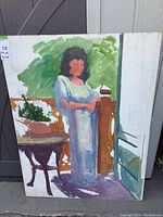 Photo of the unfinished painting of a woman standing near a round table and door, painted on board with green background