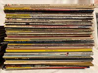Stack of classical vinyl records showing spines with composers, orchestras, and conductors names to identify items