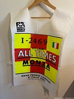 White mesh pit lane tabard printed I-2469 ALL TIMES MONZA with Italian flag and 2001 Gran Premio d’Italia text hung on wooden hanger