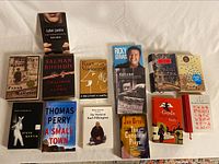Photo of various hardcover books, titles include works by Salman Rushdie, Kurt Vonnegut, Steve Martin, Thomas Perry, Frank McCourt, Kevin Roberts.