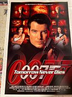 Front side of the original movie poster showing Pierce Brosnan as James Bond with the 007 logo and various characters and action scenes in the background.
