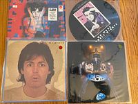 Four Paul McCartney vinyl albums arranged in a grid, showing cover art for 'Back to the Egg', 'No More Lonely Nights' picture disc, 'Tug of War', and 'McCartney II'. Covers and vinyl appear in very good condition.
