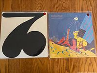 Both vinyl album covers displayed side-by-side; 'Still Life' on the right with colorful artwork, and the second album with a minimalist black and white design on the left.