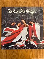 Front cover of The Kids Are Alright vinyl album showing The Who band members wrapped in a Union Jack flag.