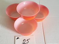 Four Anchor Hocking milk glass bowls in a red to orange gradient color, shown from an angled top-side view.