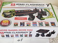 Front side of the sealed Atari Flashback 7 Deluxe Edition box highlighting console, controllers, and built-in games.
