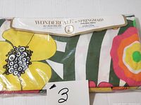 Sheet in original unopened packaging showing colorful floral pattern and Springmaid Wondercale label.