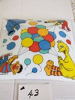 Top view of Sesame Street ceiling light shade showing Big Bird, Cookie Monster, Bert, and Ernie holding colorful balloons