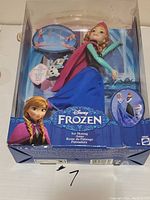 Boxed Disney Frozen Ice Skating Anna doll with accessories including Olaf figure and ice skating platform.