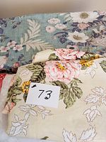 Blue floral fabric with white and pink flowers and large cream fabric with pink and yellow flowers