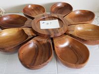 Top view showing circular wooden Lazy Susan base and eight removable wooden bowls arranged around it.