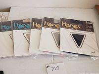 Full view of the five sealed vintage Hanes pantyhose packages laid out showing the colors and packaging details.