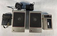 Full set including Aiwa HS-302 walkman, two Aiwa DSL portable speakers, and Sony EQ battery charger.