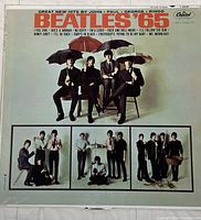 Front cover of vinyl album 'Beatles '65' with The Beatles holding umbrellas, in suits.
