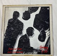 Front album cover of the Dave Brubeck Quartet vinyl showing black and white silhouettes of band members in vintage style.