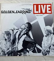 Front cover of the Golden Earring 'Live' vinyl album featuring black and white illustration of the band performing.
