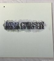 Front cover of King Crimson's Starless and Bible Black vinyl album showing title text with smoky effect on white background.