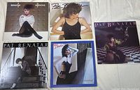 Photo showing all five Pat Benatar vinyl record album covers laid out in a grid on the floor with distinct 80s styling and photography.