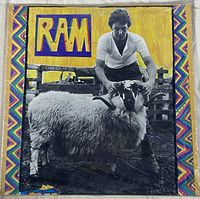 Front cover of the RAM vinyl record album showing Paul McCartney with a ram in colorful artistic cover art.