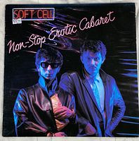 Front album cover of Soft Cell Non-Stop Erotic Cabaret vinyl record with two band members and neon style text.