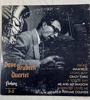 Front cover of The Dave Brubeck Quartet vinyl record showing a black and white image of a man playing piano with saxophone, album title, and tracklist.