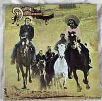 Front cover of The Doobie Brothers Stampede album showing band members on horseback in Western imagery style.