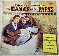 Front cover of the vinyl album showing the four members of The Mamas and the Papas seated in a bathtub with a yellow sticker about included songs.