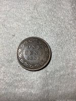 Reverse side of 1896 Canada one cent coin showing denomination ONE CENT 1896 with surrounding wreath.