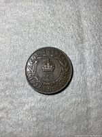 Reverse of the 1909 Newfoundland one cent coin displaying the crown, denomination, date, and laurel wreath.