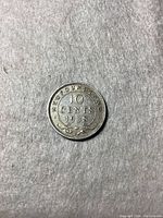 Obverse side showing 'NEWFOUNDLAND 10 CENTS 1938' with decorative elements