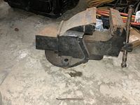 Side view of a 4-inch metalworking vise showing swivel base and rust wear