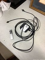 Apple TV module, HDMI cable, and remote control on a table.