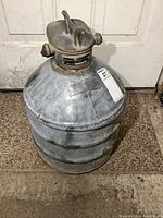 Full view of large vintage McColl Frontenac Oil Can with handle, showing overall shape and condition.