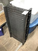 Photo of folding pet ramp folded upright showing hinges and side support ribs