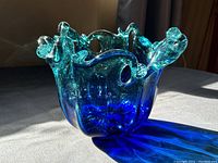 Three-quarter front view of blue glass bowl showing overall shape and color gradient
