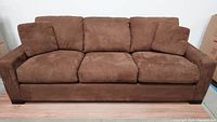 Front view of brown suede couch