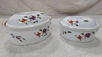 Photo showing large and small Royal Worcester Astley covered casserole dishes with floral patterns and fitted lids.