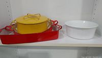 Yellow Dansk Kobenstyle roaster and red rectangular roaster with white ceramic baking dish