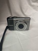 Front view of compact Canon PowerShot ELPH 510 HS camera showing lens with 6x optical zoom and 10.0 megapixels.