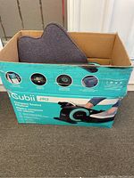 Photo of original product box with Cubii JR2 printed, seat back cushion inside the box.