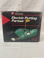 Box and front view of Electric Putting Partner showing golf balls and ramp