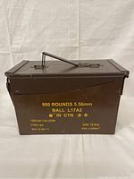 Front view of the military metal ammo box with visible stenciled markings describing contents and specifications.