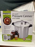 Photo of the boxed Presto 23-quart pressure canner and cooker, showing product image and some usage indication on the box.