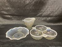Full lot view showing all three Fenton moonstone hobnail glass pieces: a creamer, a divided relish dish, and a scalloped bowl.