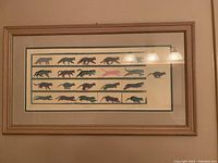 Full view of framed cat print 'Escape' showing 4 rows of cats in various colors and poses.