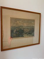 Framed antique print showing the entire piece including frame, matting, and the print itself depicting a scenic landscape.