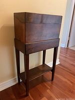 Front left angle showing closed box on stand with lower shelf visible